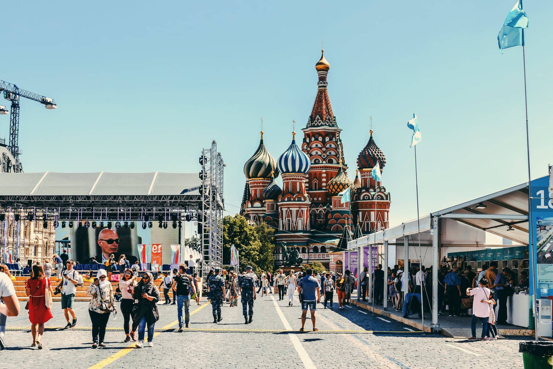 people walking near st basil s cathedral in moscow, the second supercar capital of the world